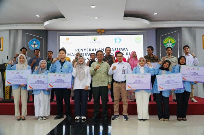 Pjs. General Manager PT SPR Langgak, Mahpuzoh (empat dari kiri) dan WR III UNRI, Prof. Hermandra (tengah) bersama dengan mahasiswa penerima beasiswa serta didampingi orang tua mahasiswa usai penyerahan beasiswa secara simbolis.
